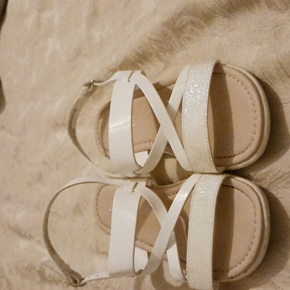Children place white sandals